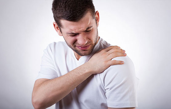 Man suffering with frozen shoulder in need of a chiropractic adjustment at Allen Auto Accident Injury Care in Allen